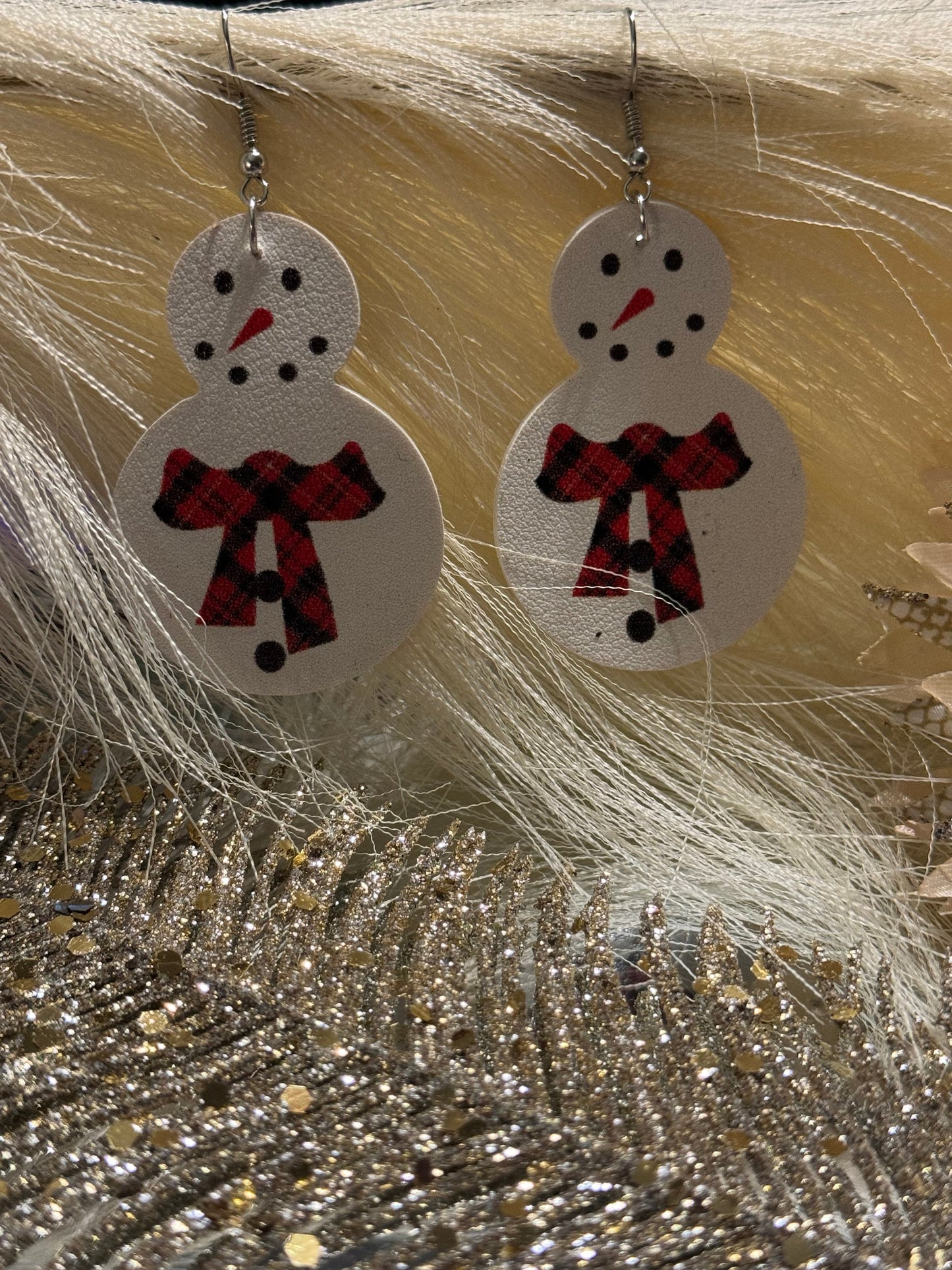 White snowman earrings with red buffalo plaid scarf