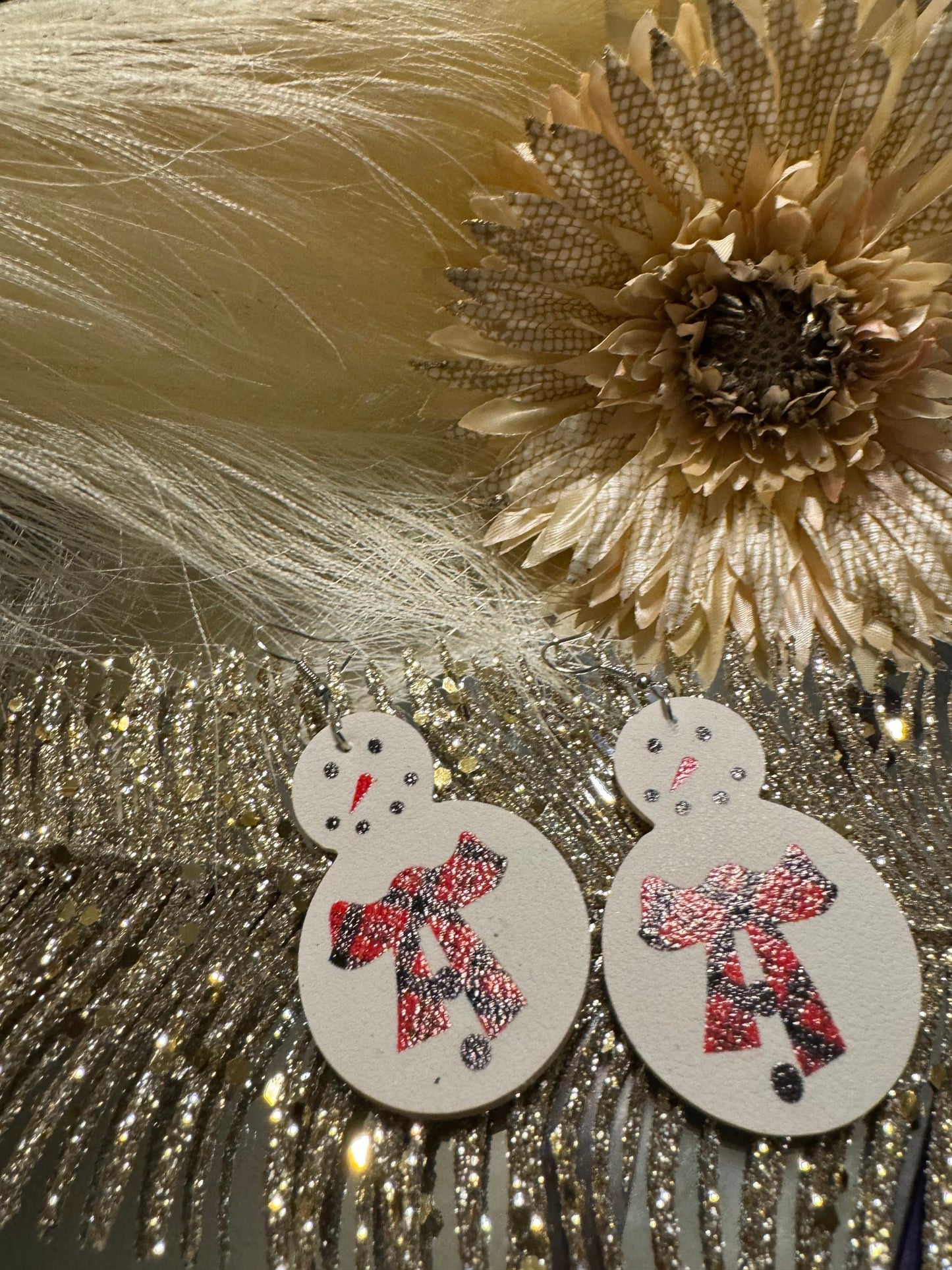 White snowman earrings with red buffalo plaid scarf