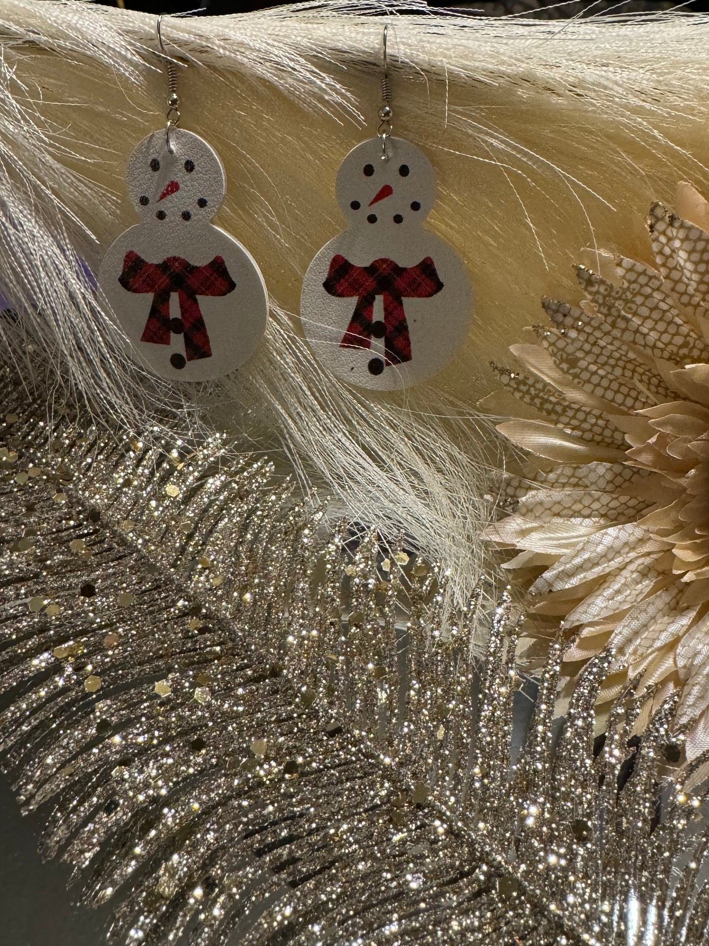 White snowman earrings with red buffalo plaid scarf