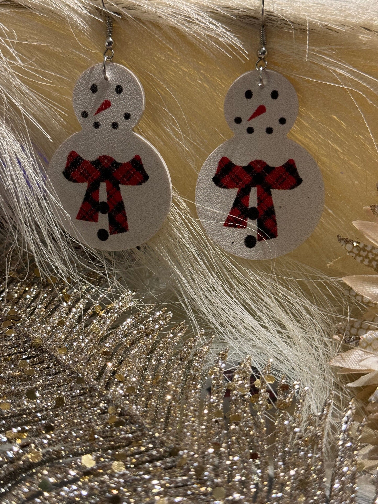 White snowman earrings with red buffalo plaid scarf