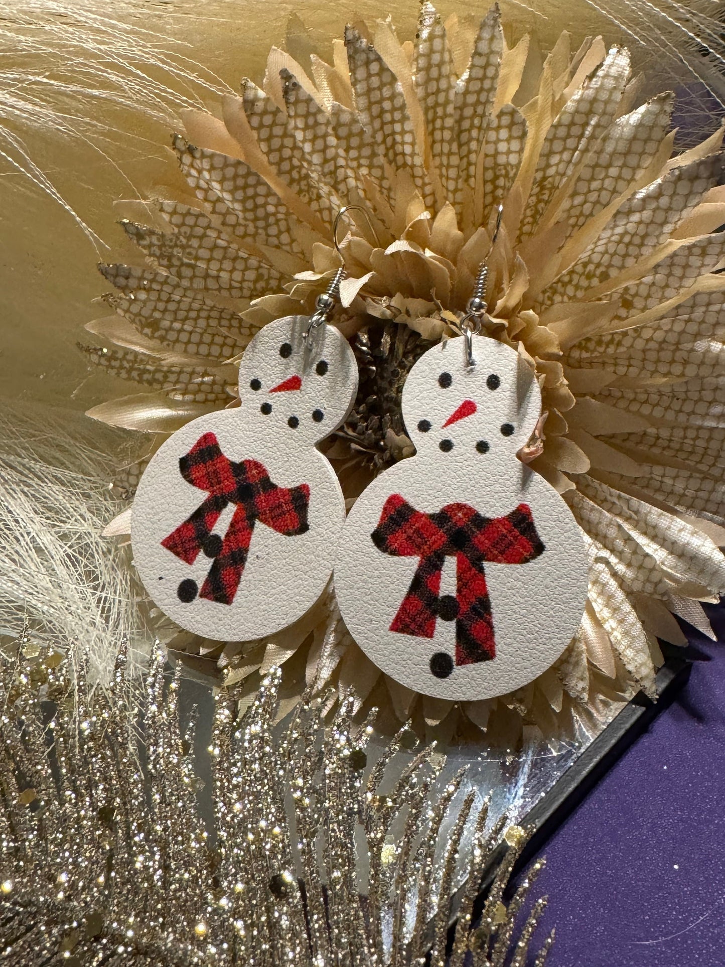 White snowman earrings with red buffalo plaid scarf